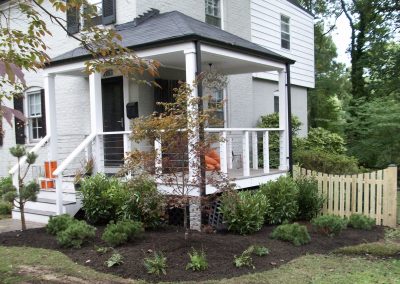 Landscaped corner of house with planted bushes